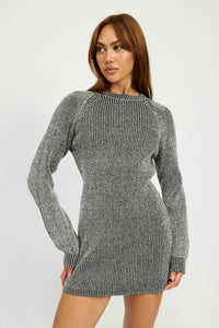 Woman wearing a gray knitted dress against a white background