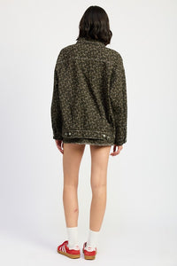 Person wearing a patterned jacket on a white background