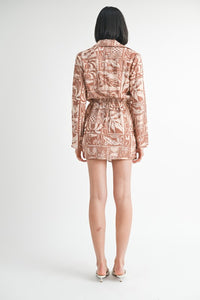 Person wearing a patterned outfit on a white background