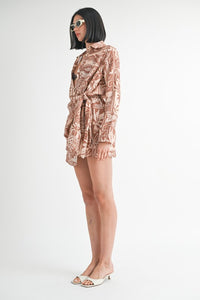 Woman wearing a patterned outfit on a white background