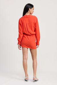 Woman wearing an orange outfit on a white background